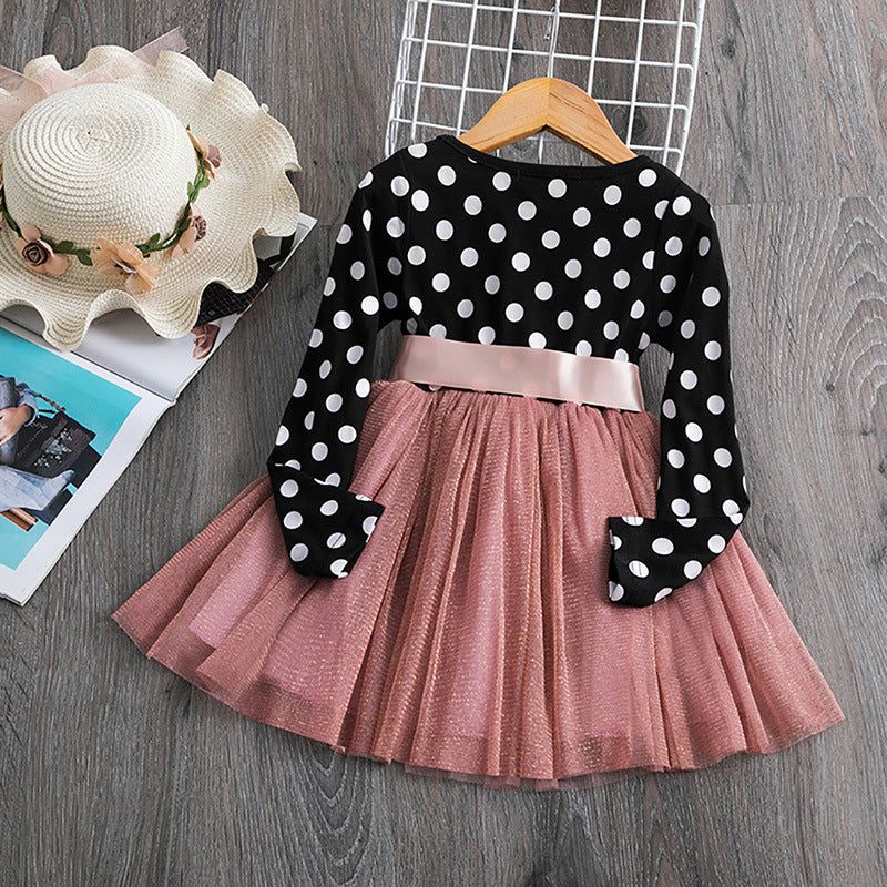Black and white polka dot long sleeve dress with pink tulle skirt, styled with straw hat