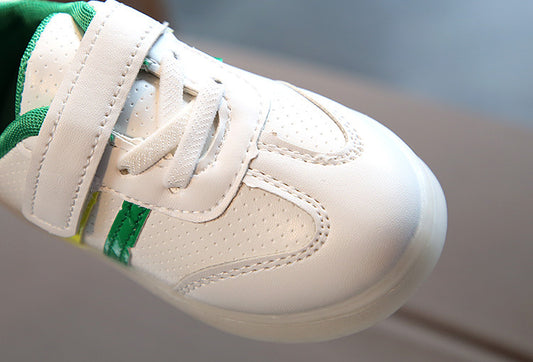 White kids sneaker with green accents, velcro strap, breathable perforations, perfect for casual wear
