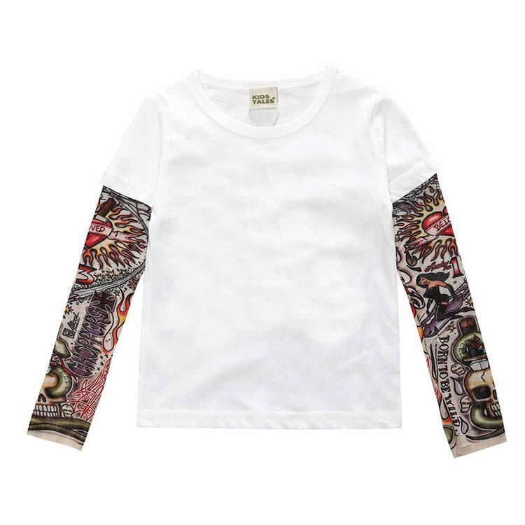 White long-sleeve kids tee with colorful tattoo-style sleeve prints, featuring skulls and flames design