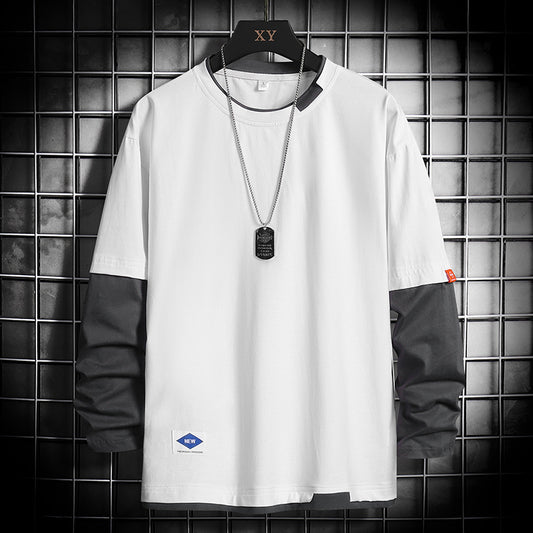 White long-sleeve color-block t-shirt with black sleeves, dog tag necklace, displayed on hanger against grid wall