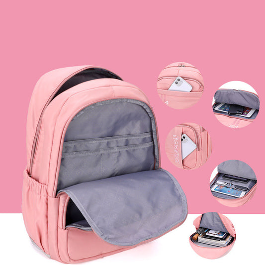 Pink backpack with gray interior, showcasing organized compartments for electronics and books