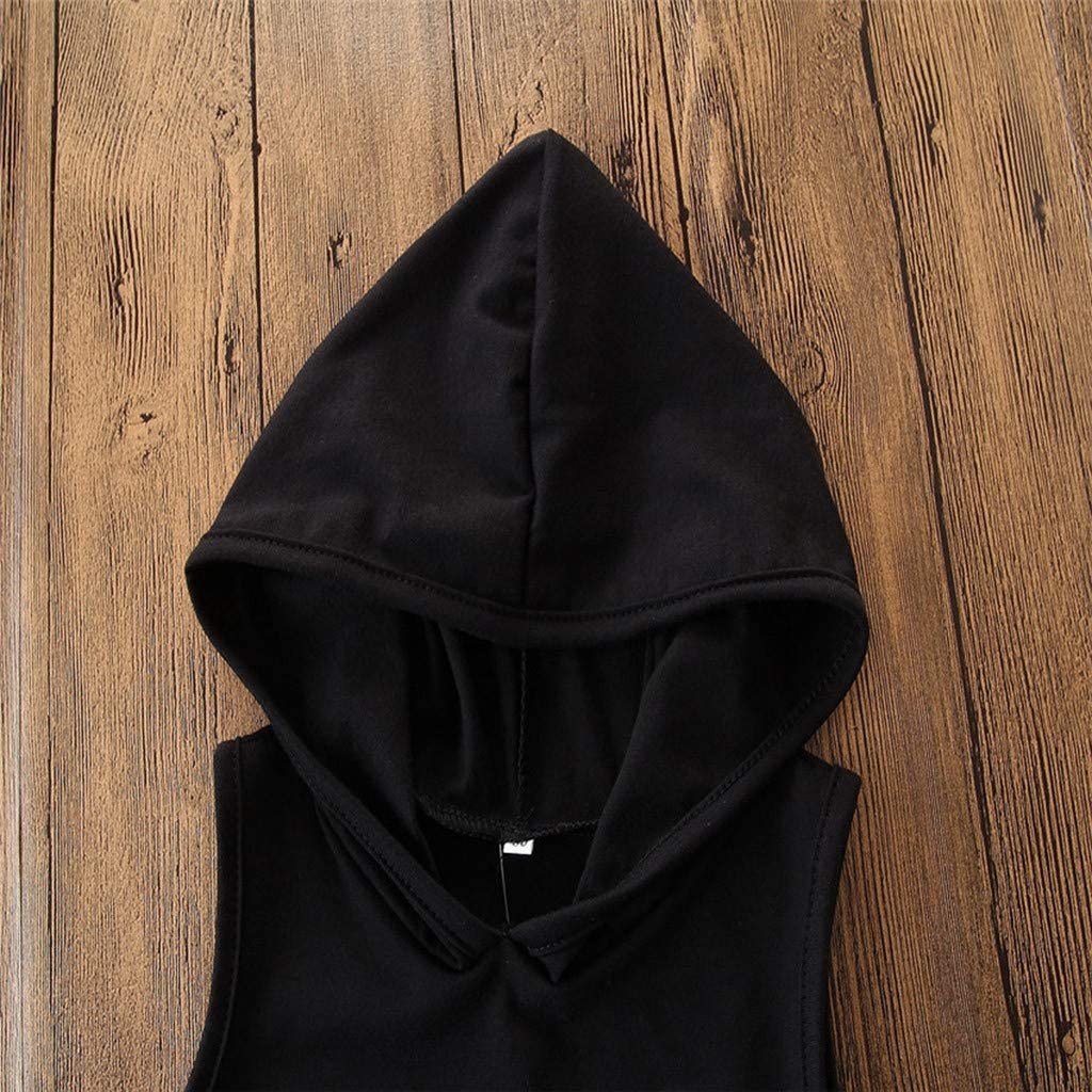Black hooded sleeveless top on wooden background, stylish casual fashion