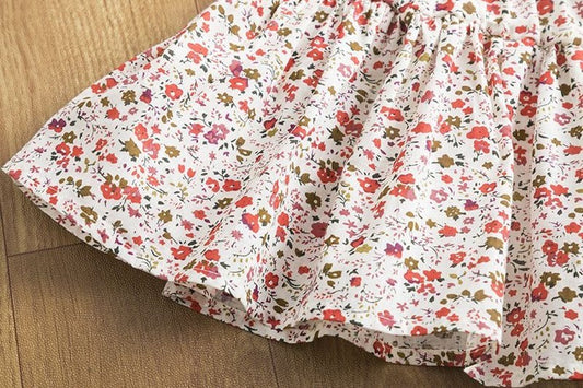 White floral dress with red and green blossoms, soft cotton fabric, perfect for spring fashion