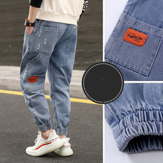 Boys' loose western-style jeans and trousers for primary school students, by Ancient Energy, shown in a casual fashion pose.
