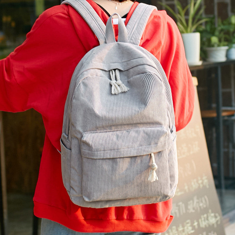 Ancient Energy corduroy backpack for students with shoulder straps, ideal for school and daily use, in a stylish design.