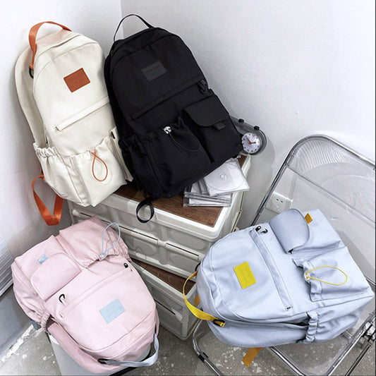 Ancient Energy nylon backpack school bag for junior high students with adjustable straps and multiple compartments.