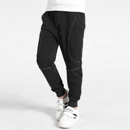 Boy wearing Ancient Energy boys' sports trousers, lightweight athletic pants with elastic waistband and sporty design.