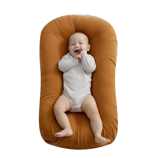 Ancient Energy baby nest bed crib for newborns, portable cotton cot and travel cradle with cushioned support for infants.