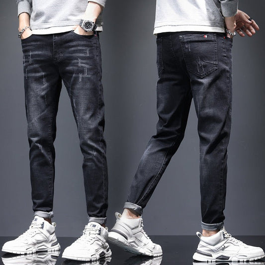 Men's ripped denim jeans with cat-whisker scratches by Ancient Energy, showing distressed denim with stylish, intentional tears and scratches.