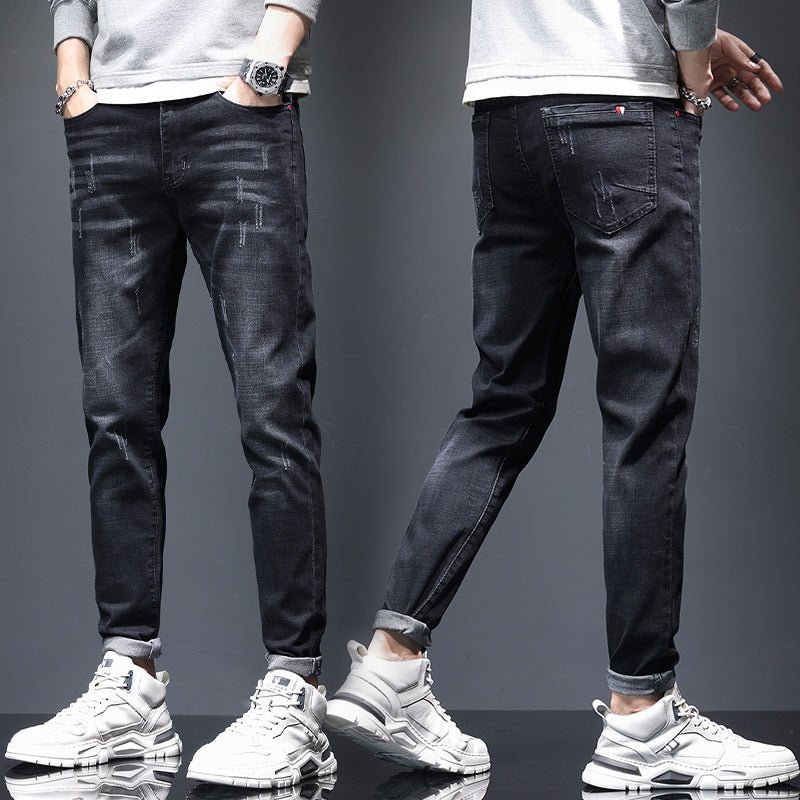 Men's ripped denim jeans with cat-whisker scratches by Ancient Energy, showing distressed denim with stylish, intentional tears and scratches.