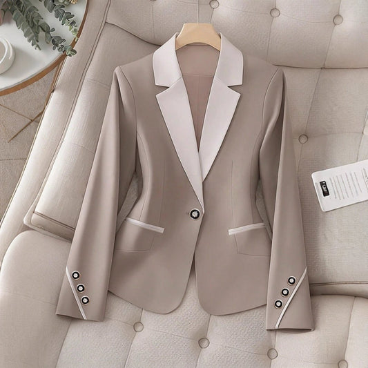 Elegant formal blazer by Ancient Energy with contrasting color buttons, tailored for a sophisticated professional look.
