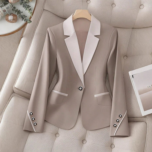 Elegant formal blazer by Ancient Energy featuring contrasting color buttons and a tailored fit for professional or dressy occasions.