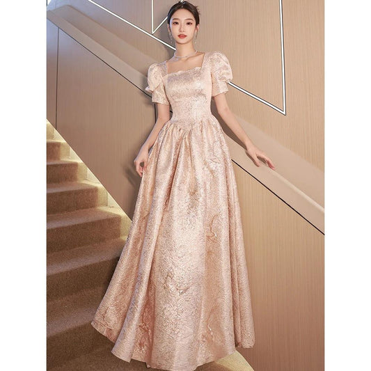 Women’s champagne evening dress by Ancient Energy featuring elegant design and flowing fabric for formal occasions.