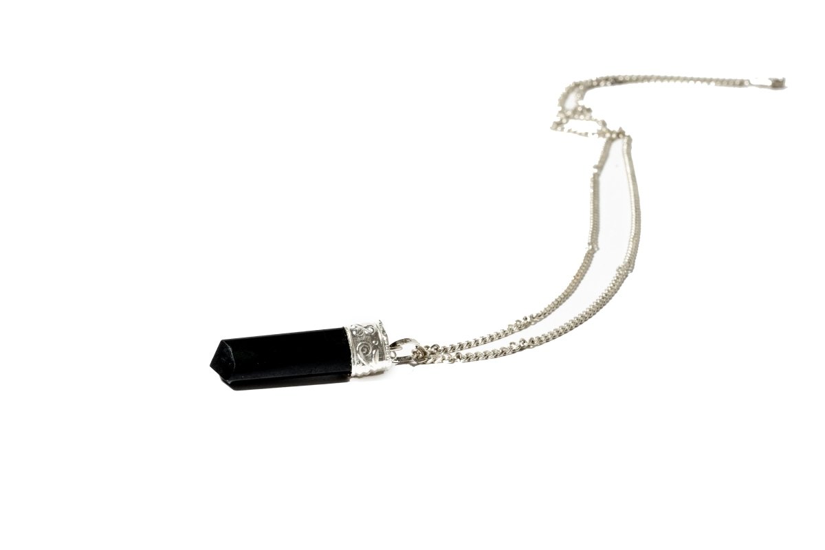 Silver-plated Black Tourmaline Protection Pendant from Ancient Energy, showcasing a polished black gemstone on a silver chain.