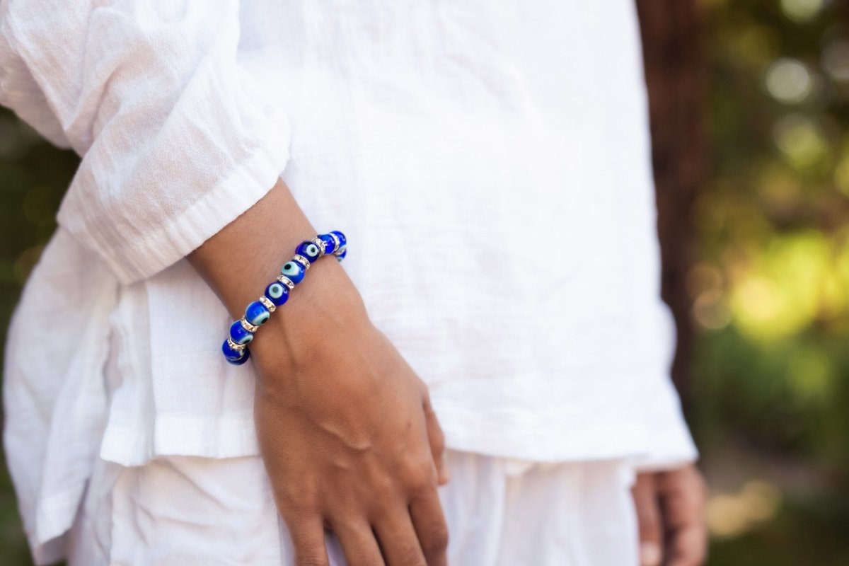 Ancient Energy Evil Eye Protection Bracelet featuring blue and white beads on a leather cord for warding off negative energy.