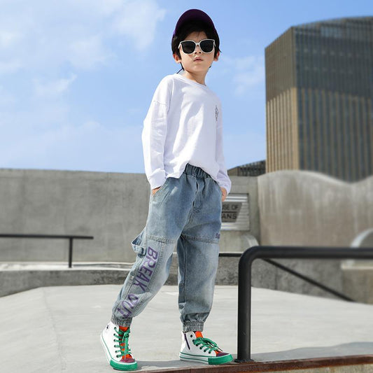 Boys' loose Western style jeans and trousers for primary school students by Ancient Energy, shown in a casual school outfit.