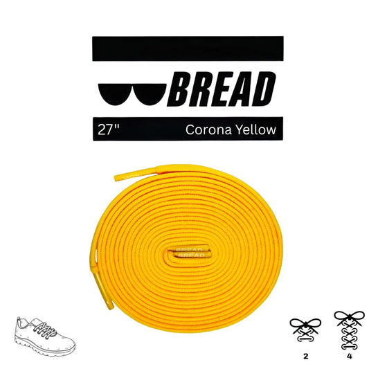 Elastic shoelace by Bread in vibrant Corona Yellow, shown with the lace threaded through shoe eyelets.