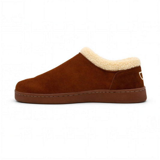 Men's Bread Ashton suede slippers resting on a wooden surface, featuring soft suede material and a cozy design.