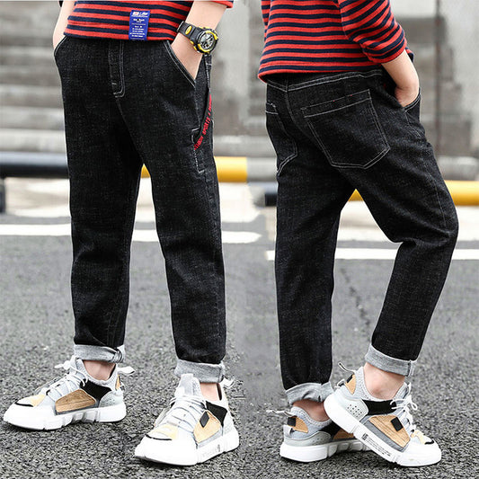 Boy wearing Ancient Energy velvet one-piece jeans for autumn and winter, featuring a cozy, stylish denim design.