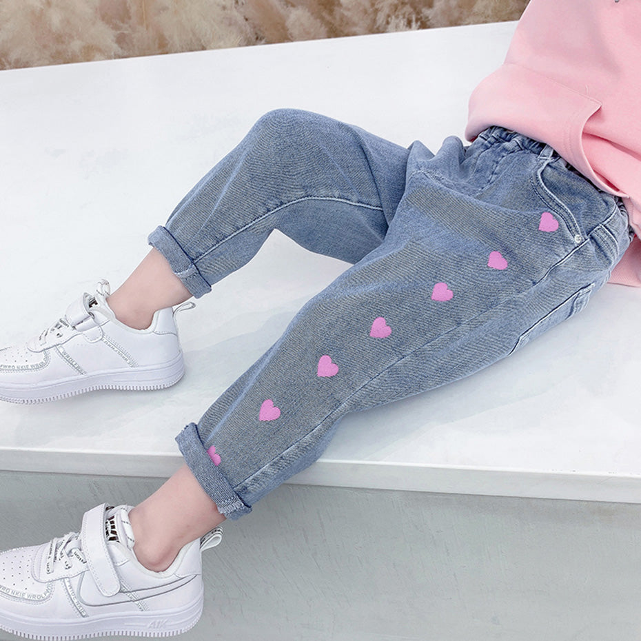 Girls' casual thin love stretch jeans by Ancient Energy, showing a close-up of the slim-fit denim with a light wash and stretchy fabric