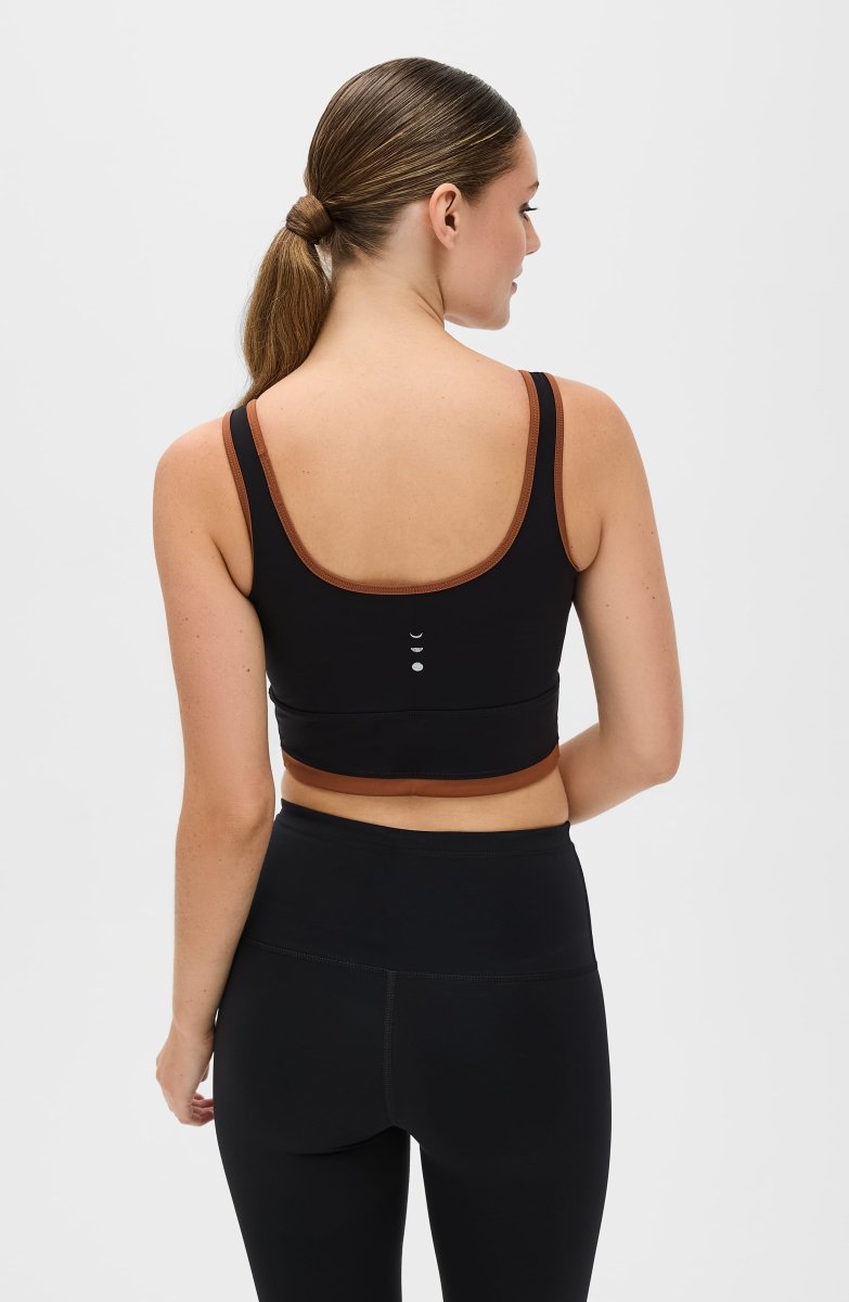 Elastique Athletics Lisse Bra in Chestnut and Black, showcasing a fitted athletic top with supportive design and moisture-wicking fabric.