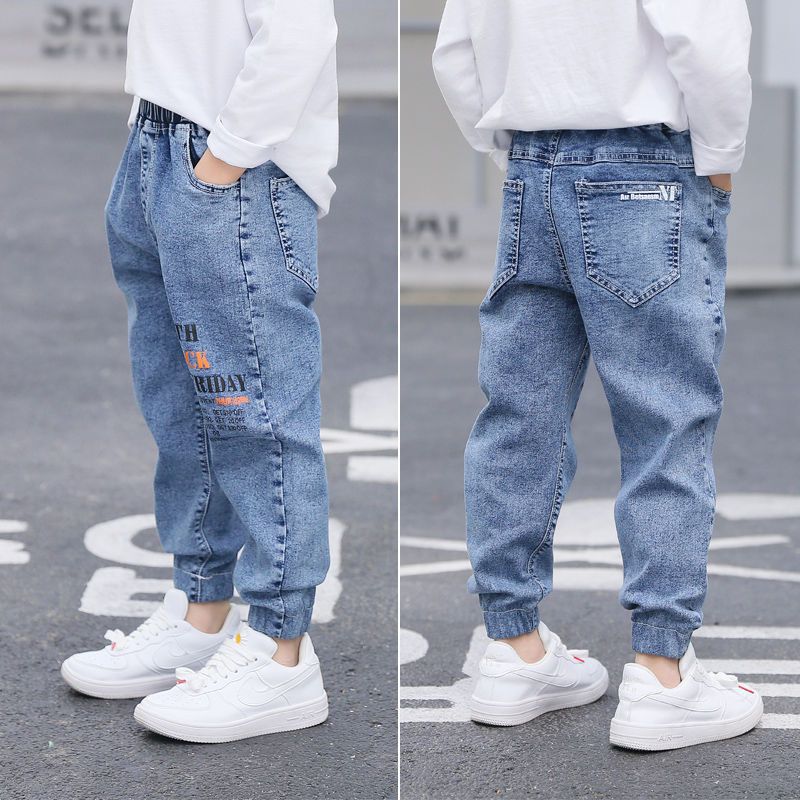 Young boy wearing blue boys' jeans from Ancient Energy’s spring and autumn collection, casual style and comfortable fit.