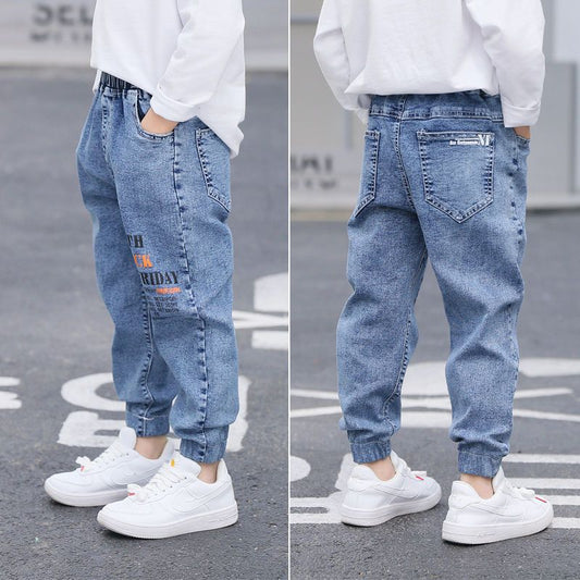 Young boy wearing blue boys' jeans from Ancient Energy’s spring and autumn collection, casual style and comfortable fit.