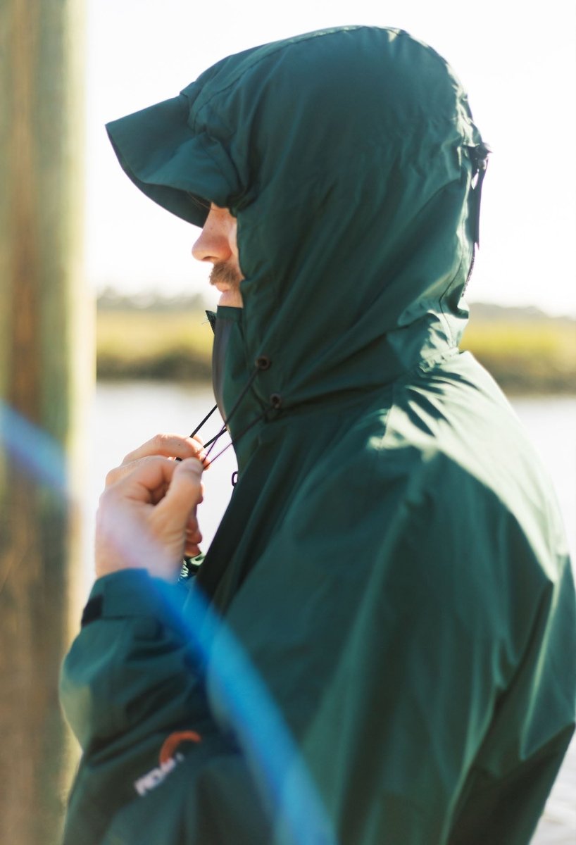IWOM WeatherShield Convertible Jacket shown in black, featuring a hood and multiple zipper pockets for versatile weather protection.