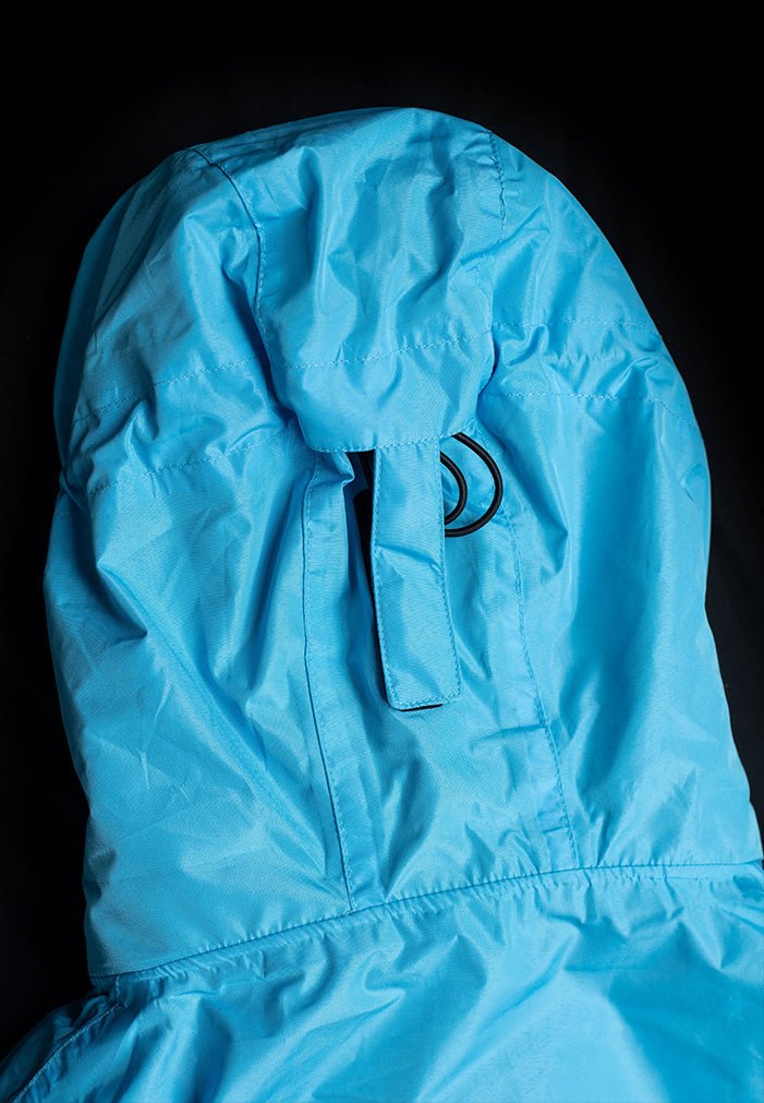 IWOM WeatherShield Convertible Jacket shown in navy, featuring a zip-off hood, multiple pockets, and adjustable cuffs for versatile outdoor wear.
