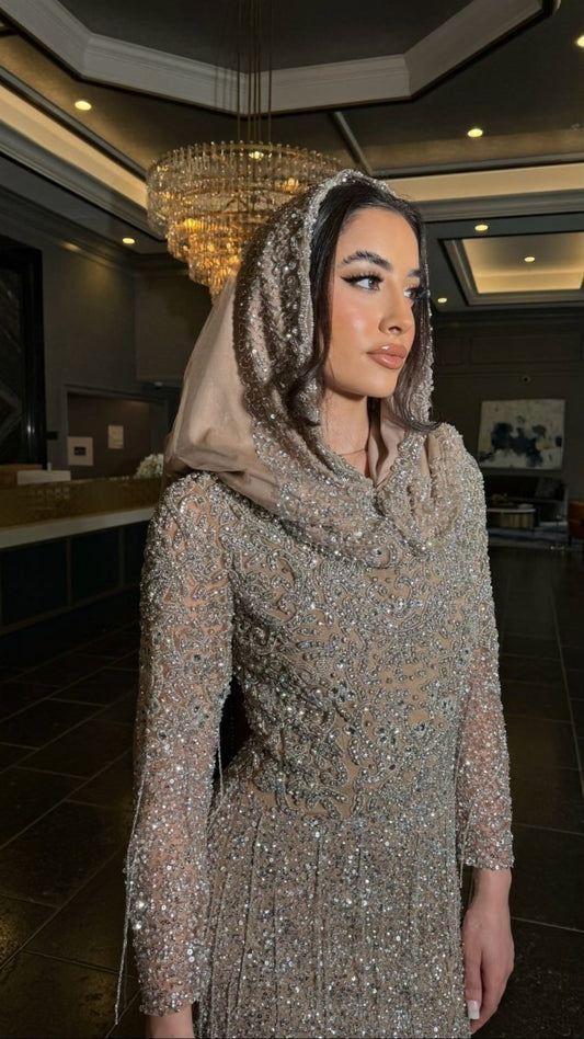 Iyza Belaar Aleya embellished scarf styled as a long dress hijab headwrap with intricate embellishments and elegant design.