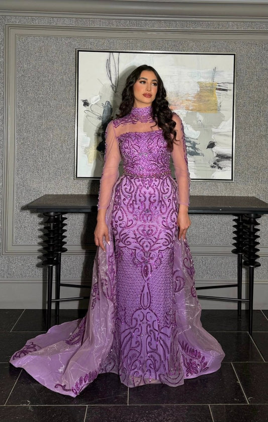 Elegant Iyza Belaar Deema long dress with high neckline, tulle fabric, and intricate embroidery, perfect for formal occasions.