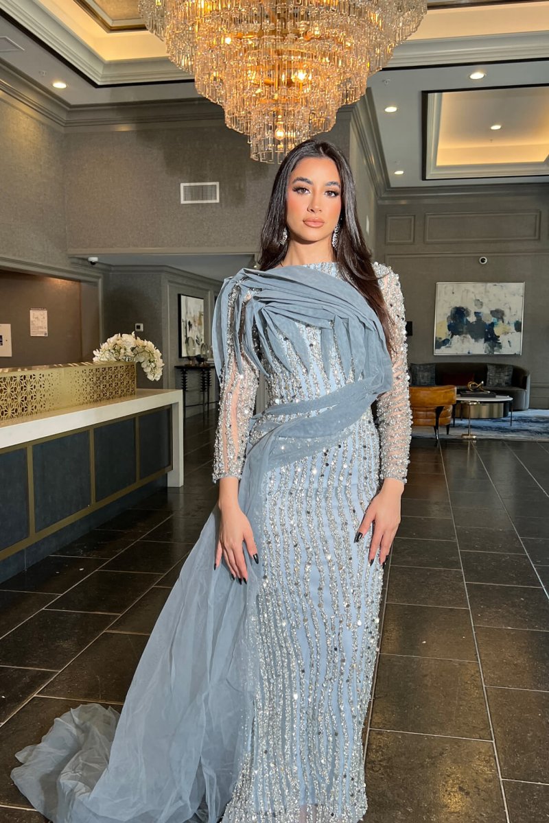 Iyza Belaar Imani long sleeve side skirt dress, elegant long dress with side slit and fitted silhouette, stylish evening wear.