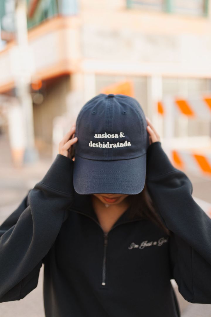 Navy blue Ansiosa & Deshidratada cap by JZD, featuring a curved brim and adjustable strap, shown on a plain background.