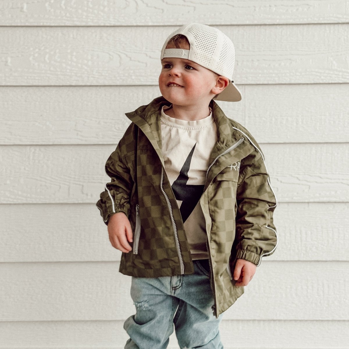 Little Rad Things Storm Rider waterproof jacket in army green, lightweight and weather-resistant for outdoor wear.