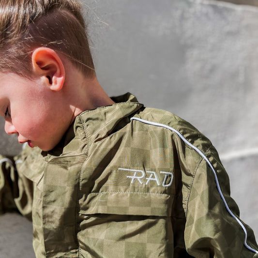 Little Rad Things Storm Rider waterproof jacket in army green, lightweight and weather-resistant for outdoor protection.