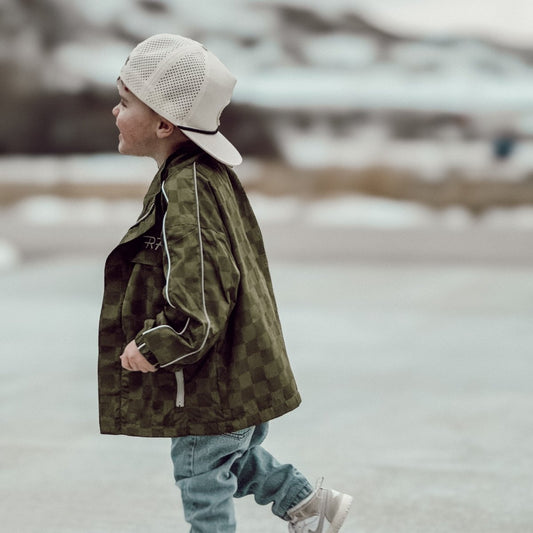 Little Rad Things Storm Rider waterproof jacket in army green, shown with weather-resistant fabric and adjustable hood.