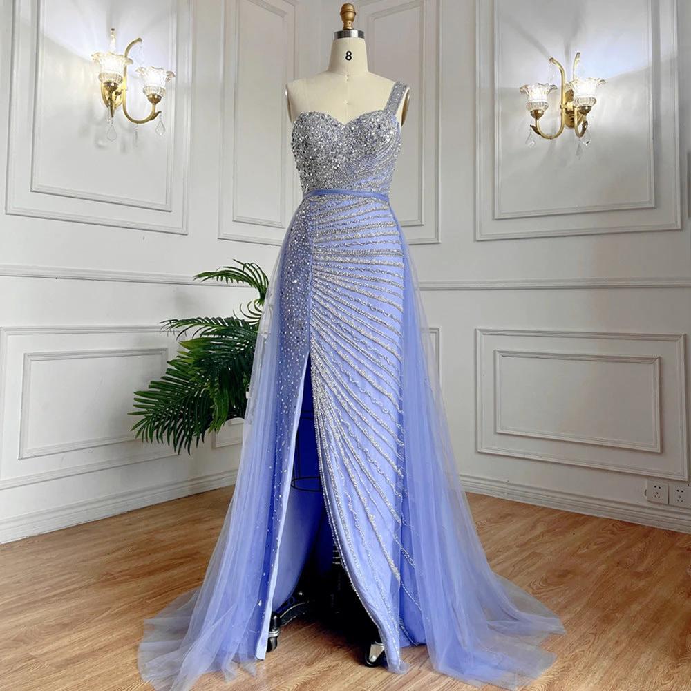 Blue handmade beaded split shoulder fishtail dress by MANDOTOS, featuring intricate beadwork and a flowing silhouette.