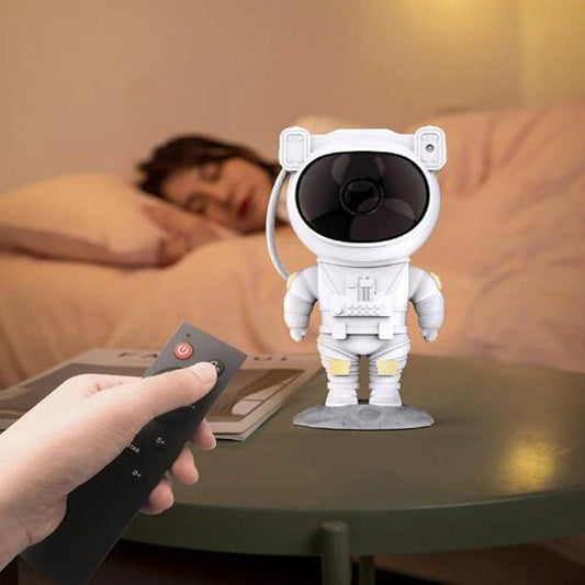 Mandotos creative astronaut galaxy starry sky projector nightlight illuminating a bedroom with USB-powered atmospheric lighting.