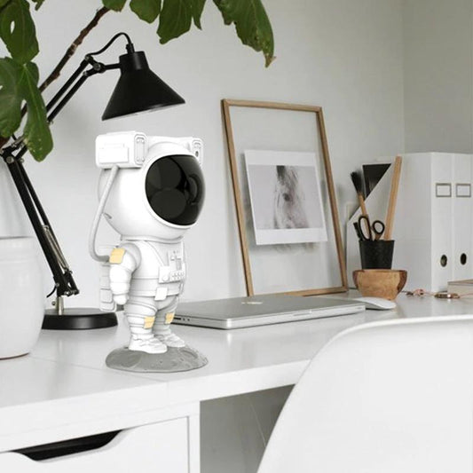 Mandotos creative astronaut galaxy starry sky projector nightlight USB bedroom table lamp illuminating a starry sky scene.
