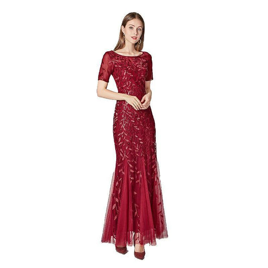 Elegant black evening dress by MANDOTOS featuring a flowing silhouette and stylish neckline, perfect for formal occasions.