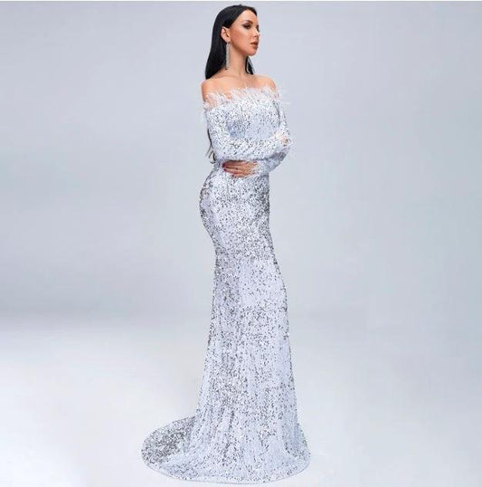 Elegant black evening dress by MANDOTOS featuring a flowing silhouette and off-shoulder design, perfect for formal occasions.
