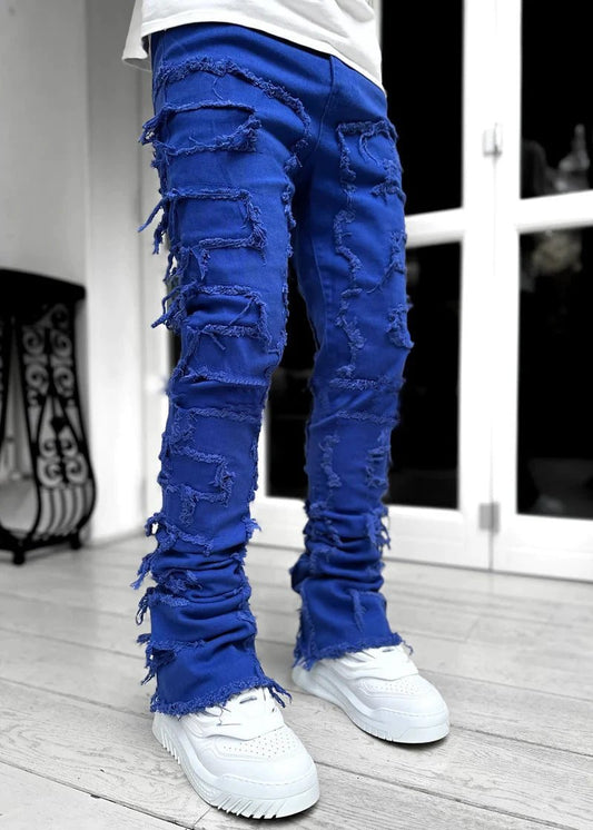 Men's stacked jeans by MANDOTOS, long tight fit trousers with patched details, showcasing bold style and modern denim design.