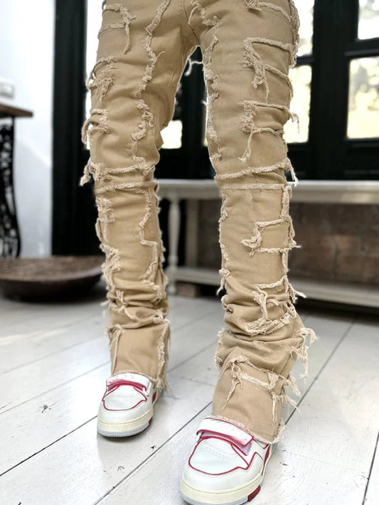 Men's stacked jeans by MANDOTOS with patched details, long tight fit trousers for a bold street style look.