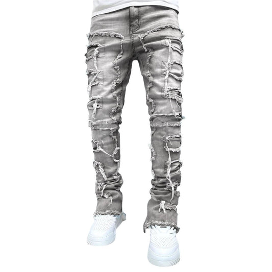 Men's stacked patched jeans by MANDOTOS, long tight fit trousers with bold style, featuring individual patched details.