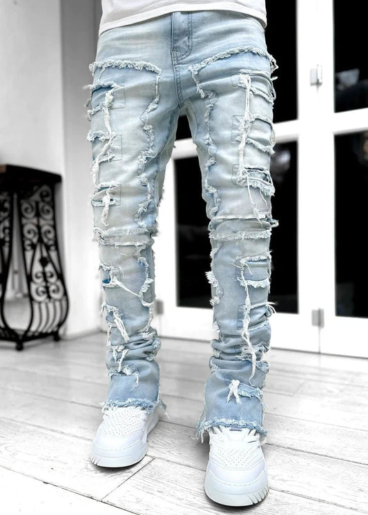 Men's stacked jeans by MANDOTOS with patched design, long tight fit trousers showcasing a bold style and distressed details.