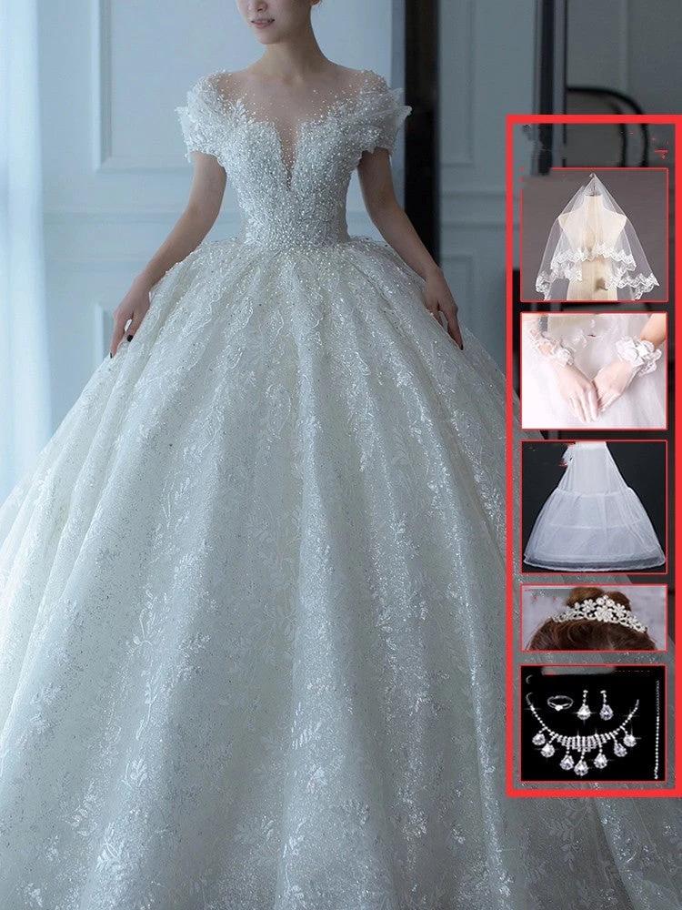 Off-shoulder French main wedding dress by MANDOTOS, featuring elegant lace details and a flowing train for bridal elegance.