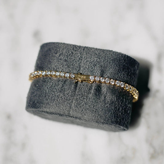 18K gold-plated zircon tennis bracelet by MANDOTOS featuring sparkling cubic zirconia stones and a sleek, elegant design.