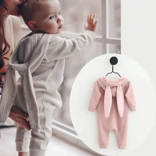 Pink bunny ear baby onesie by MANDOTOS featuring soft fabric and adorable bunny ear hood for infants.