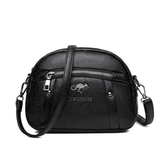Mandotos chic leather circle purse with adjustable strap and minimalist design, perfect for casual or evening use.