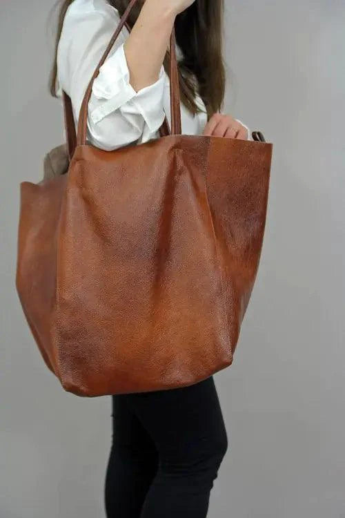 Mandotos chic leather tote handbag with sturdy handles and spacious interior, ideal for daily use and stylish accessorizing.